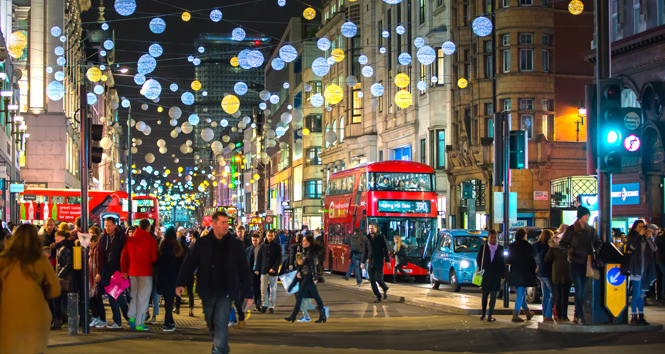 Christmas lights at Regent street, lots of people walking, public transport, buses and taxis.