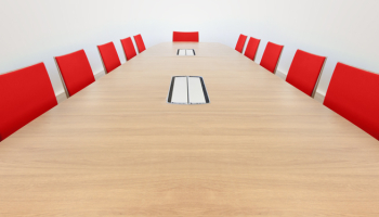 Empty board room with red chairs