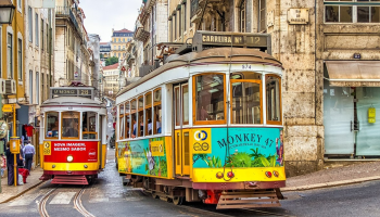 A photo of two yellow trams in Lisbon, Portugal